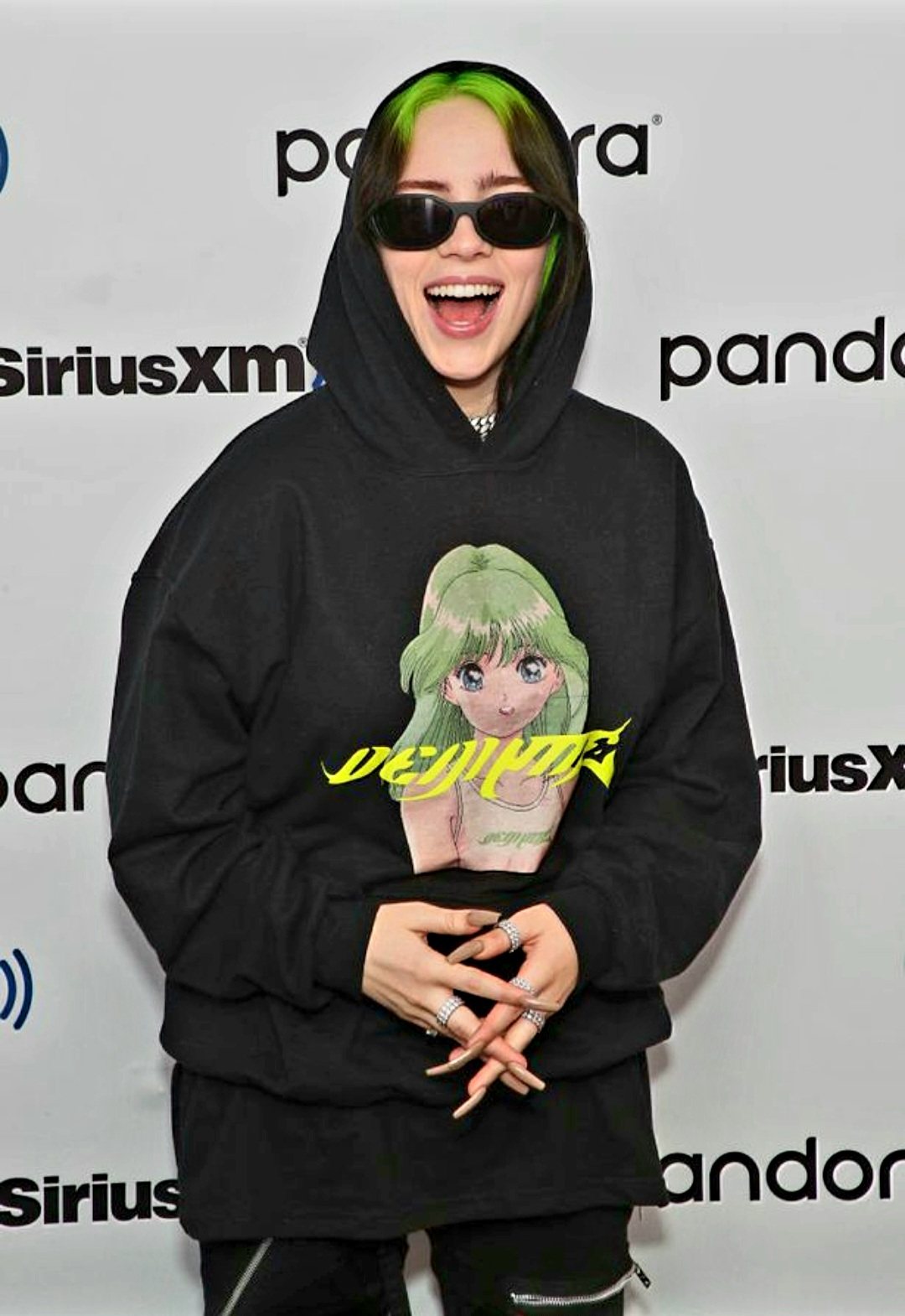 Billie Eilish wearing oversized hoodie and cargo pants